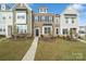 Two-story townhome with brick and siding exterior, landscaping, and walkway at 939 Cobbled Way, Fort Mill, SC 29715