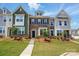 Charming townhome showcases a well-manicured lawn, varied siding, and a welcoming front entrance at 939 Cobbled Way, Fort Mill, SC 29715