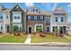 Charming townhome showcases a well-manicured lawn, varied siding, and a welcoming front entrance at 939 Cobbled Way, Fort Mill, SC 29715