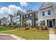 Beautiful townhome exteriors feature manicured lawns, brick, and varied architectural designs with lush landscaping at 939 Cobbled Way, Fort Mill, SC 29715