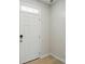 Clean, simple entryway with white trim, a solid white door, and durable wood-look flooring at 939 Cobbled Way, Fort Mill, SC 29715