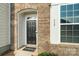 Black front door with welcome mat at 939 Cobbled Way, Fort Mill, SC 29715