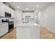 Contemporary kitchen with white cabinets, island, and stainless steel oven at 939 Cobbled Way, Fort Mill, SC 29715