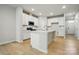 Open kitchen showcases white cabinetry, island, and stainless steel appliances at 939 Cobbled Way, Fort Mill, SC 29715