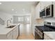 Kitchen view with island, stainless steel appliances, and open living space at 939 Cobbled Way, Fort Mill, SC 29715