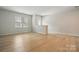Spacious living room with light wood floors, and bright windows and door at 939 Cobbled Way, Fort Mill, SC 29715