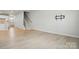 Open-concept living area with hardwood floors, stairs, and TV mount at 939 Cobbled Way, Fort Mill, SC 29715