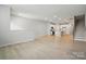 Open living area with wood floors, stairs, and a view into the kitchen at 939 Cobbled Way, Fort Mill, SC 29715