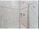 Clean shower with tile surround and built-in seat at 939 Cobbled Way, Fort Mill, SC 29715