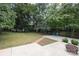 Spacious backyard with patio, fire pit, and mature trees at 1422 Morningside Dr, Charlotte, NC 28205