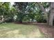 Spacious backyard with lush lawn and mature trees at 1422 Morningside Dr, Charlotte, NC 28205