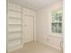 Small bedroom with built-in shelving and window at 1422 Morningside Dr, Charlotte, NC 28205