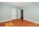 Simple bedroom with hardwood floors and neutral walls at 1422 Morningside Dr, Charlotte, NC 28205