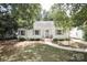 Charming white brick home with gray shutters and landscaped lawn at 1422 Morningside Dr, Charlotte, NC 28205