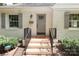Gray front door with brick steps and gray shutters at 1422 Morningside Dr, Charlotte, NC 28205