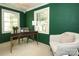 Serene home office with a desk, chair, and green walls at 1422 Morningside Dr, Charlotte, NC 28205