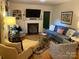 Cozy living room features a fireplace, comfy seating, and hardwood floors at 1422 Morningside Dr, Charlotte, NC 28205