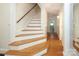 Elegant staircase with hardwood floors and white risers at 1422 Morningside Dr, Charlotte, NC 28205
