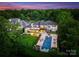 Stunning aerial view of the property showcasing its luxurious pool and lush landscaping in a private setting at 2116 Woodhaven Rd, Charlotte, NC 28211