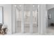 Modern, bright shower room featuring floor to ceiling tile, frameless shower doors and dual shower heads at 2116 Woodhaven Rd, Charlotte, NC 28211