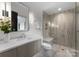 Modern bathroom featuring sleek vanity, frameless glass shower with bench, and contemporary fixtures at 2116 Woodhaven Rd, Charlotte, NC 28211