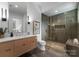 Sleek bathroom showcasing a marble vanity, frameless glass shower, and modern lighting fixtures at 2116 Woodhaven Rd, Charlotte, NC 28211