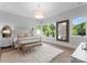 Cozy bedroom with large windows, soft natural light, and plush rug for added comfort at 2116 Woodhaven Rd, Charlotte, NC 28211