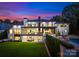 Spacious two-story home featuring outdoor patio, pool area, and views of the well-manicured lawn at 2116 Woodhaven Rd, Charlotte, NC 28211