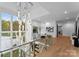 Grand foyer featuring a glass railing, stairs, an elegant light fixture, and hardwood floors at 2116 Woodhaven Rd, Charlotte, NC 28211