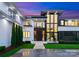 Elegant front entrance with modern door, manicured landscaping and unique architectural details at 2116 Woodhaven Rd, Charlotte, NC 28211