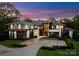 Striking front exterior featuring modern architecture, a circular driveway, and professionally landscaped grounds at 2116 Woodhaven Rd, Charlotte, NC 28211
