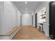 Minimalist hallway with hardwood floors, built-in storage, and a sleek workstation, blending functionality and style with clean lines at 2116 Woodhaven Rd, Charlotte, NC 28211