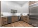Bright kitchen featuring stainless steel appliances, sleek white cabinetry, and hardwood floors at 2116 Woodhaven Rd, Charlotte, NC 28211