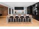 Stylish kitchen island with marble countertop, dark cabinets, and seating, creating a perfect spot for casual dining and socializing at 2116 Woodhaven Rd, Charlotte, NC 28211