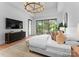 Bright and spacious main bedroom featuring a wall of windows, a chandelier, and a sitting area at 2116 Woodhaven Rd, Charlotte, NC 28211