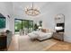 Bright main bedroom with a chandelier, view of nature and hardwood flooring at 2116 Woodhaven Rd, Charlotte, NC 28211