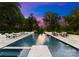 Long, narrow pool with lounge chairs, manicured landscaping, a view of the sky and twilight sunset at 2116 Woodhaven Rd, Charlotte, NC 28211