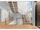 Modern staircase with glass railings and unique lighting fixtures, adding a touch of elegance at 2116 Woodhaven Rd, Charlotte, NC 28211