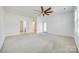 Spacious bedroom with neutral carpet, ceiling fan, and en suite bathroom and walk in closet at 4023 Home Grown Way, Lake Wylie, SC 29710