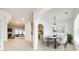 Bright dining room with modern light fixture, arched doorways, and white wood floors at 4023 Home Grown Way, Lake Wylie, SC 29710