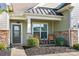 Inviting front porch with rocking chairs and stone accents at 4023 Home Grown Way, Lake Wylie, SC 29710