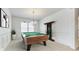 Well-lit game room featuring a billiard table, elegant chandelier, and detailed trim at 4023 Home Grown Way, Lake Wylie, SC 29710