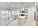 Open-concept kitchen features an island, stainless steel appliances, and views into the living area at 4023 Home Grown Way, Lake Wylie, SC 29710