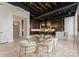 Open dining area with glass table and gold chairs adjacent to kitchen at 127 Tryon N St # 503, Charlotte, NC 28202