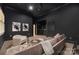 Dark-walled home theater with comfortable seating and a wet bar at 127 Tryon N St # 503, Charlotte, NC 28202