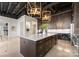 Modern kitchen with dark cabinetry, large island, and high ceilings at 127 Tryon N St # 503, Charlotte, NC 28202