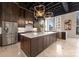 Modern kitchen with dark cabinetry, large island, and high ceilings at 127 Tryon N St # 503, Charlotte, NC 28202