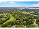 Aerial view of property lines amidst lush landscaping, golf course, and lake, offering a serene and private setting at 130 Stonewall Beach Ln, Mooresville, NC 28117