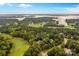 Aerial view of waterfront estate with golf course and lake views, showcasing the property's prime location at 130 Stonewall Beach Ln, Mooresville, NC 28117