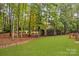 Spacious backyard with lush green grass, mature trees, and a serene ambiance at 130 Stonewall Beach Ln, Mooresville, NC 28117